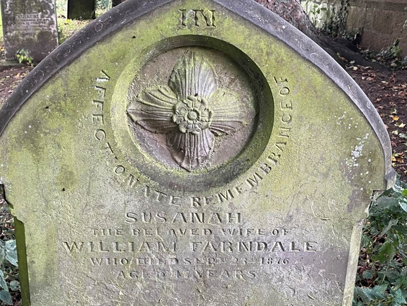A picture containing text, outdoor, grass, gravestone
Description automatically generated